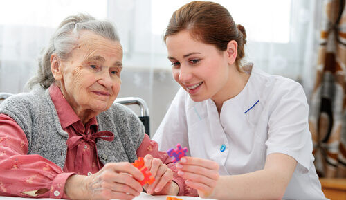 lady with dementia in a care home with a carer